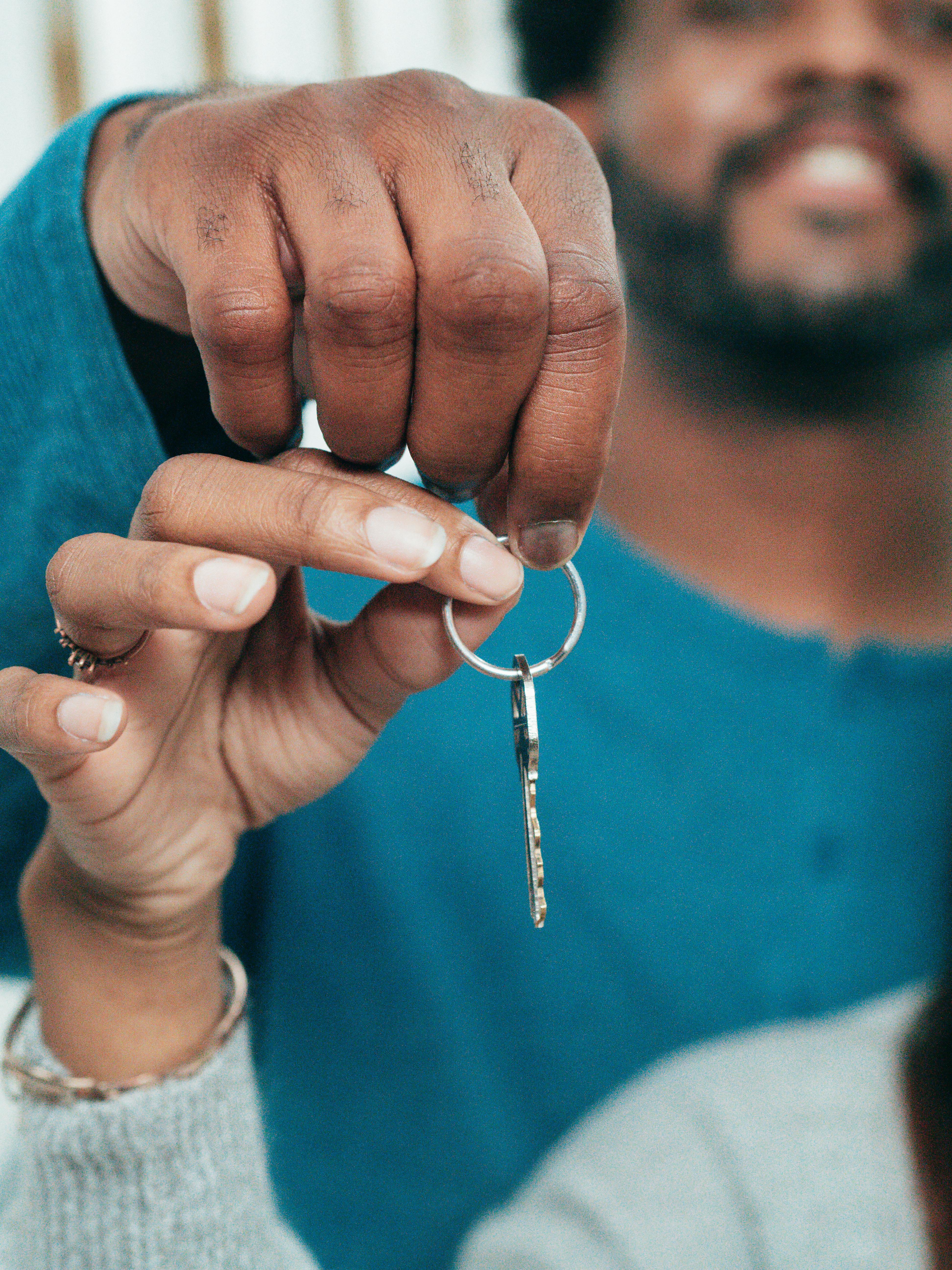 people holding a key