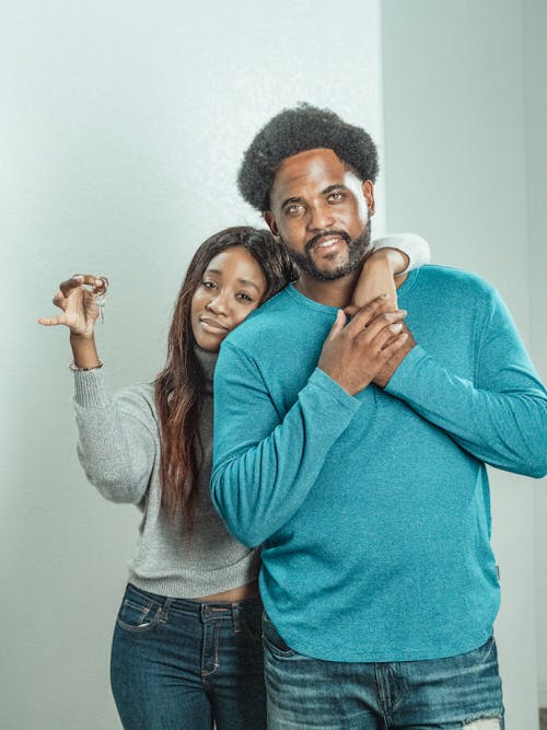Free Woman in Gray Sweater Hugging Man in Blue Long Sleeve Shirt Stock Photo