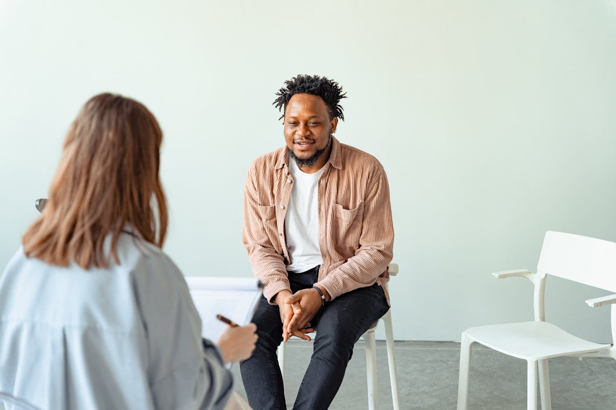 Person in therapy session discussing sleep problems with counselor