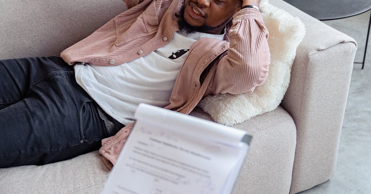 A therapist sessions with a worried man lying on a sofa, addressing mental health concerns.
