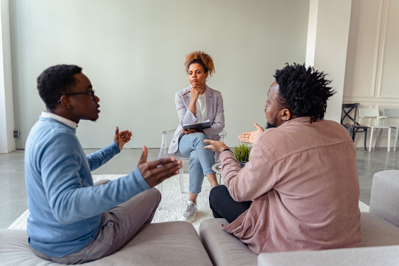 A therapy session featuring a diverse group discussing issues