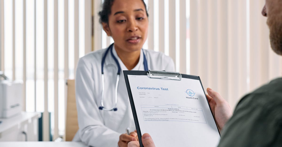 Doctor having a consultation with a patient over coronavirus test results in a medical office.