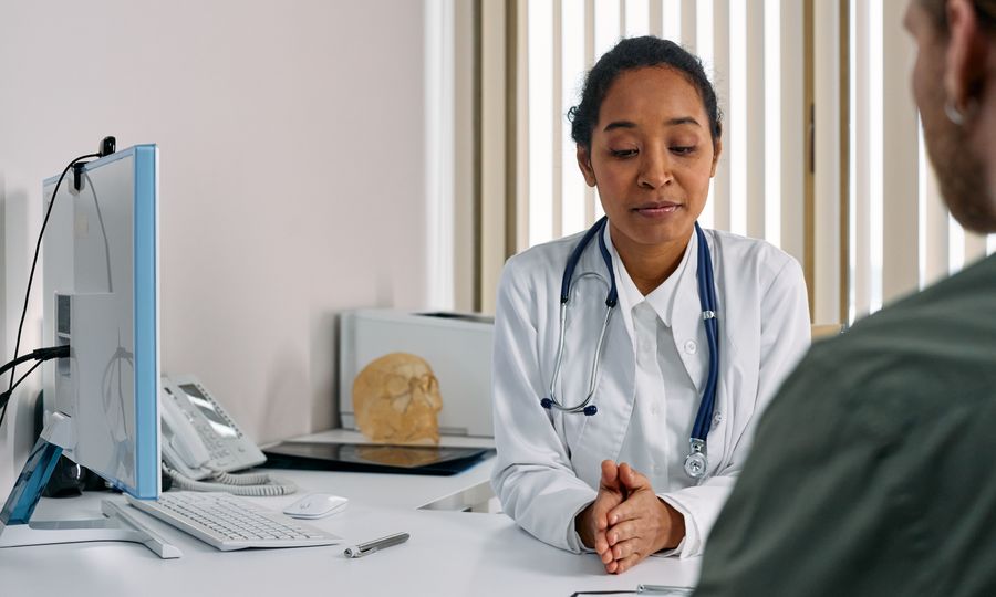 Doctor speaking with a patient in a bright office