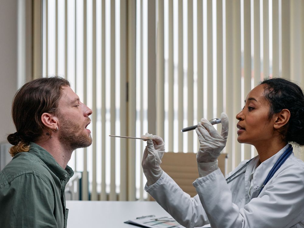 Doctor examining a patient's throat