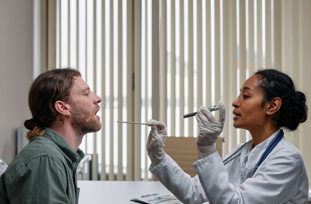 Doctor examining a patient's throat