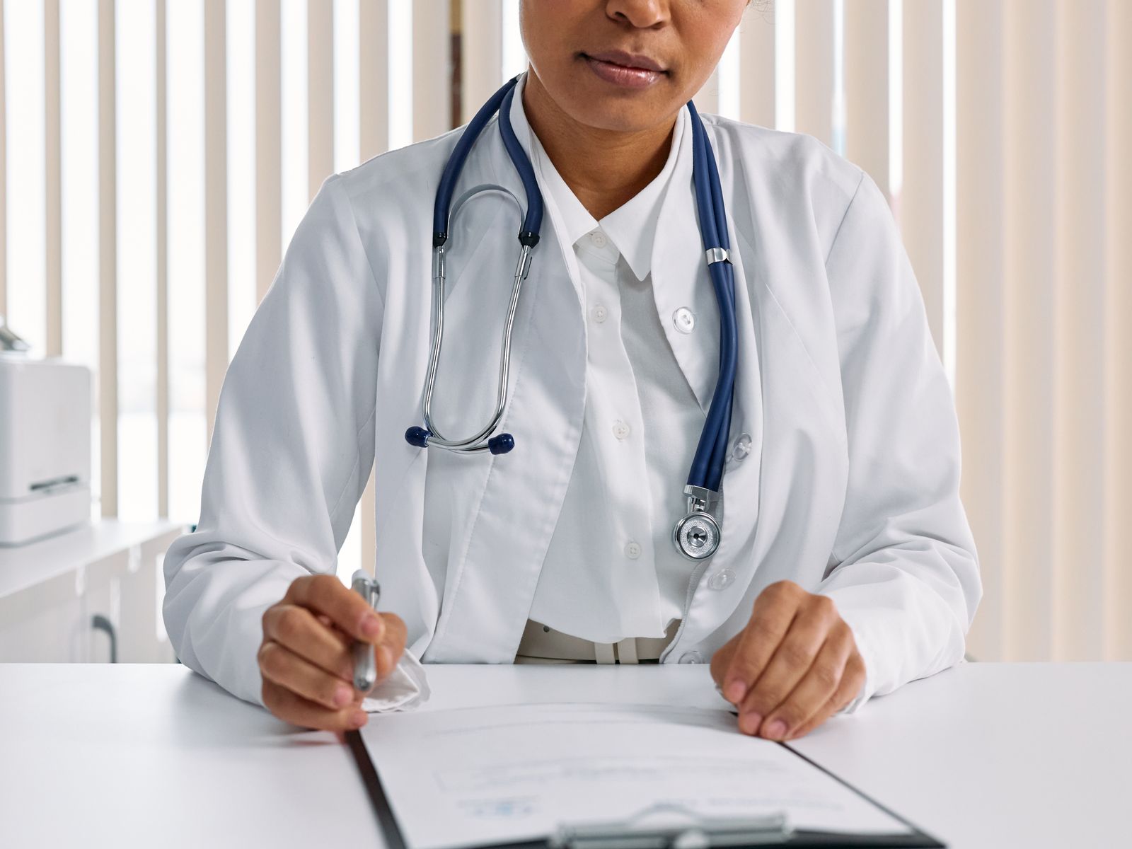 Healthcare professional using a laptop or tablet in a modern practice office