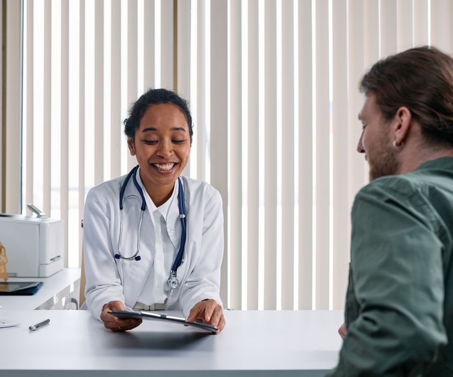 Healthcare professional reviewing health education resources with a friendly smile