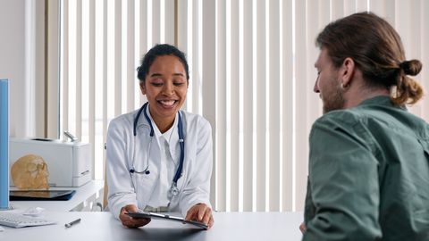 A doctor and patient engaging in a positive consultation in a bright clinic setting.