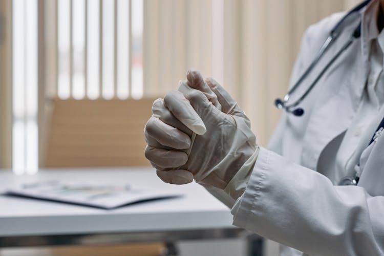 Clasped Hands With Disposable Latex Gloves