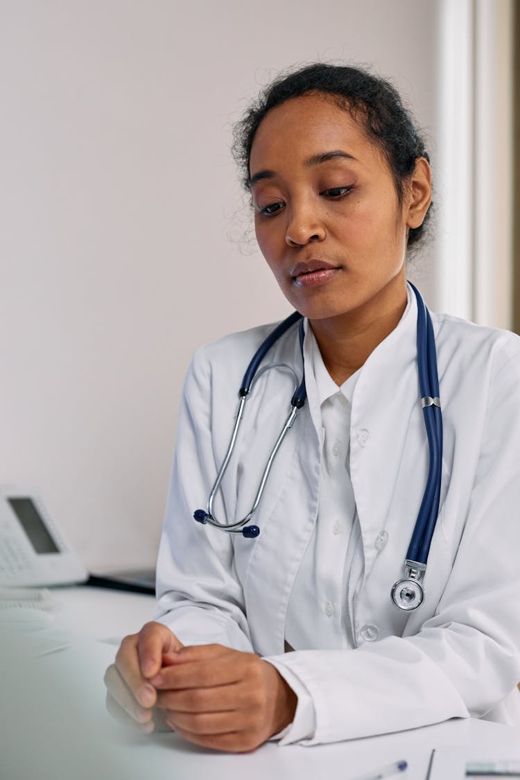 Woman In White Suit With Blue Stethoscope 