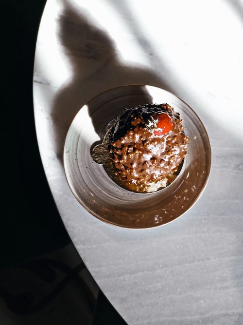 Free Top view of a chocolate dessert with cherry topping on a marble table, artistic shadows. Stock Photo
