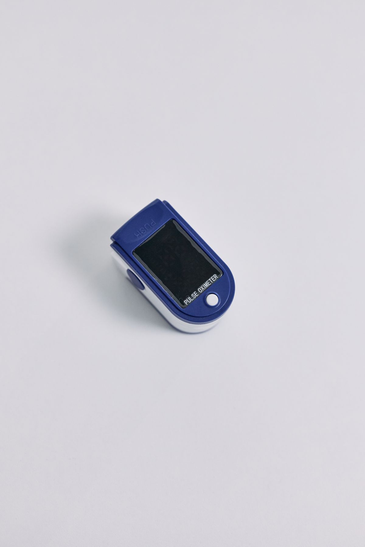 A compact fingertip oximeter on a clean white surface, ready for home monitoring