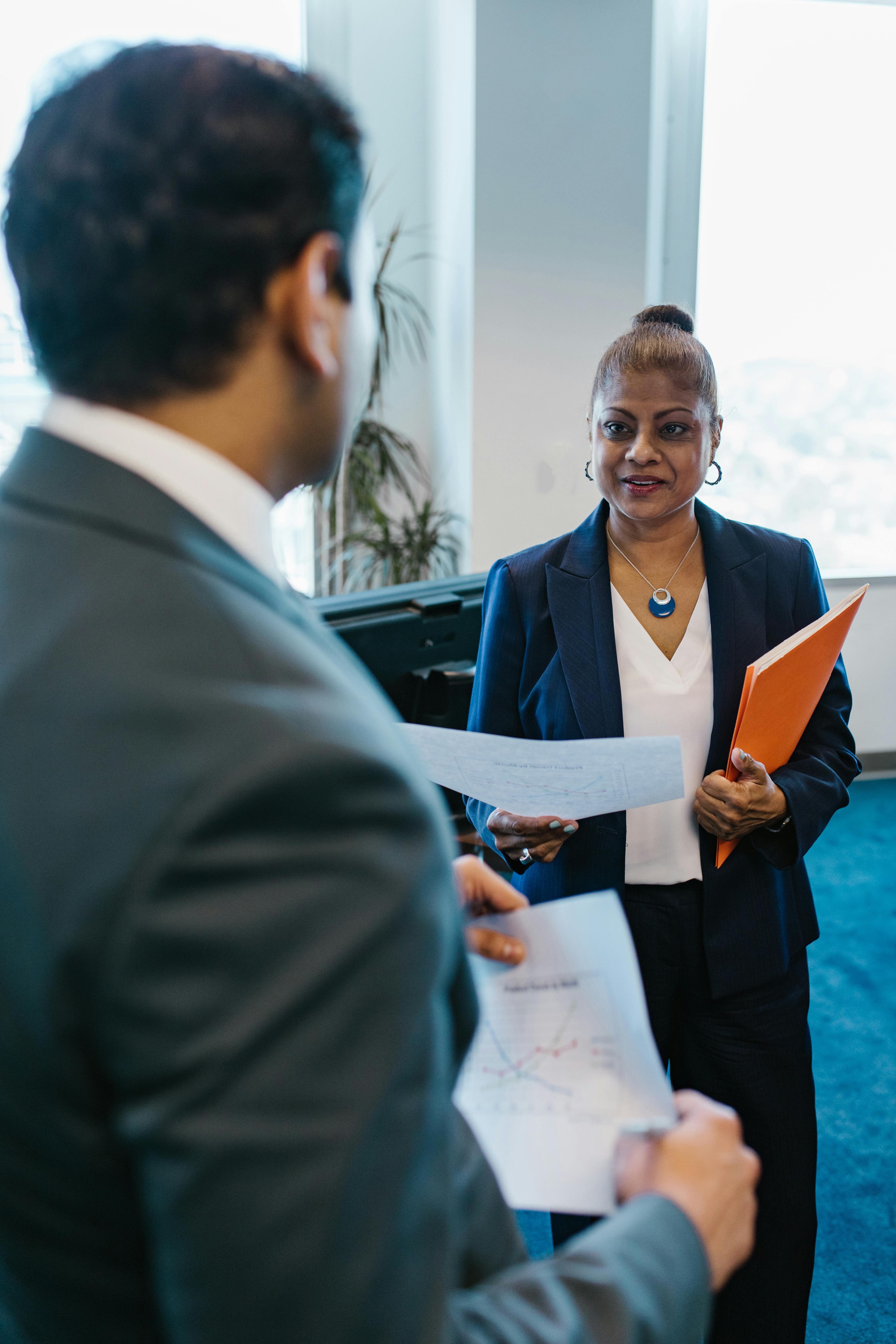 Woman Wearing a Blazer Holding a Paper