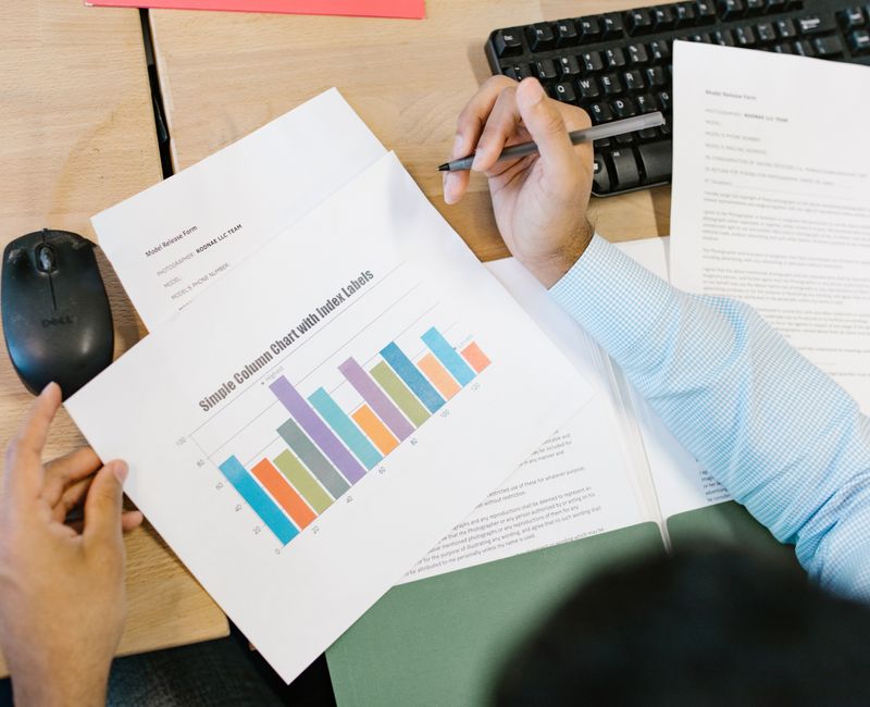 A financial analyst reviewing business financial projections on a computer