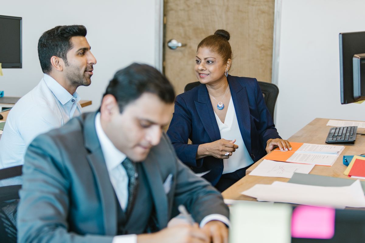 Two colleagues discussing ideas in an office
