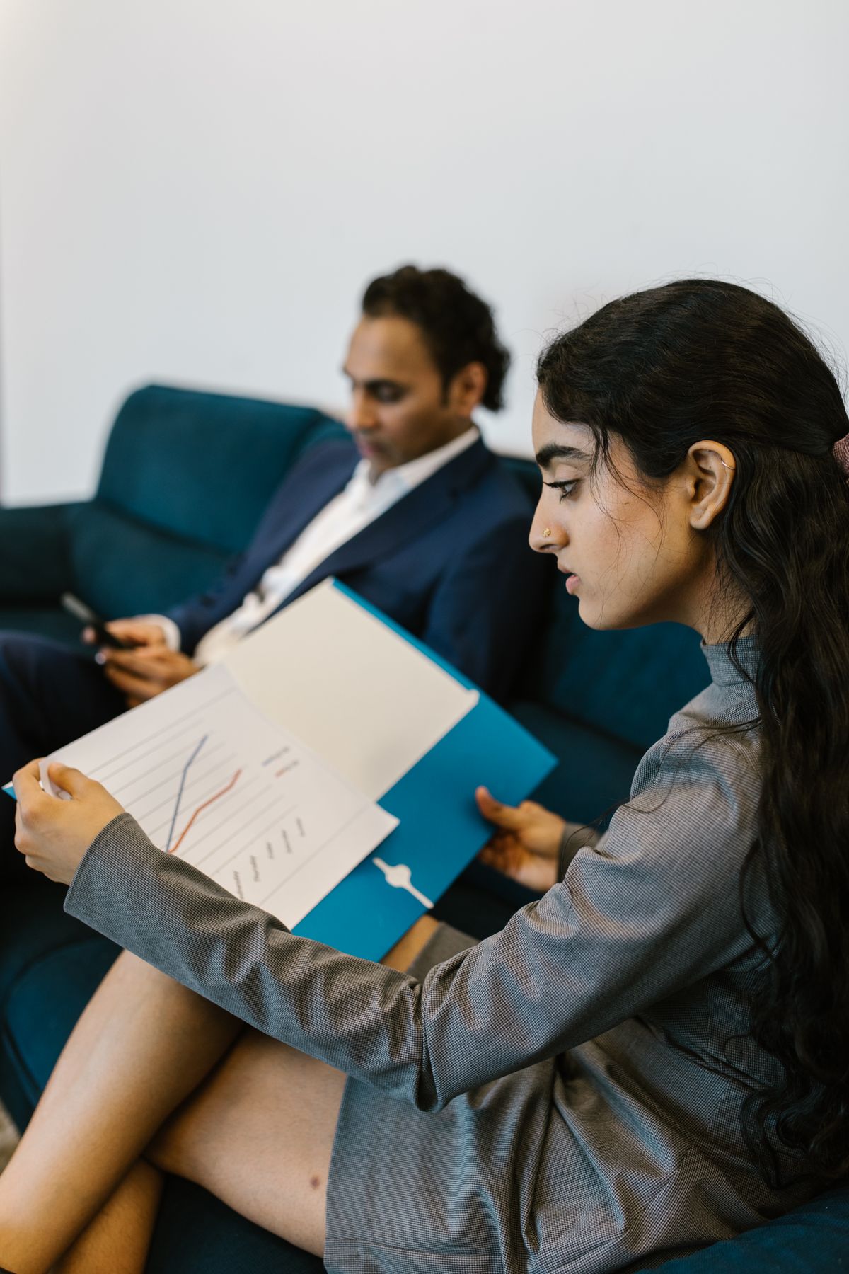 Two professionals reviewing financial charts in an office