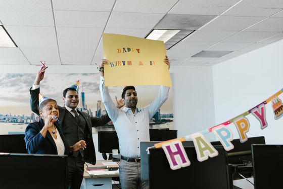 Colleagues in party hats mid-celebration — RDNE Stock project on Pexels