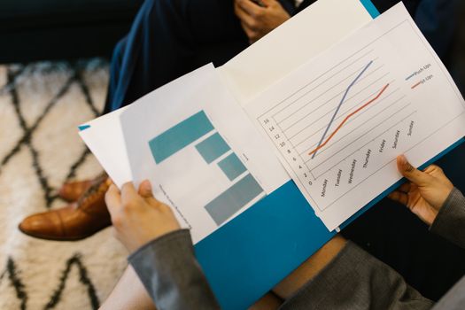 Detailed view of business reports with graphs during a corporate meeting.