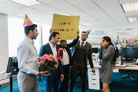 Surprise office birthday celebration with joyful colleagues and festive decorations.