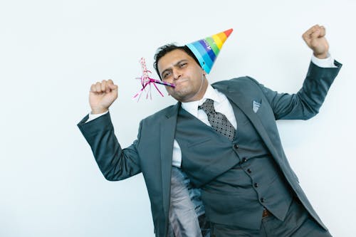 Man in Black Suit Jacket Holding Red Yellow and Blue Flag