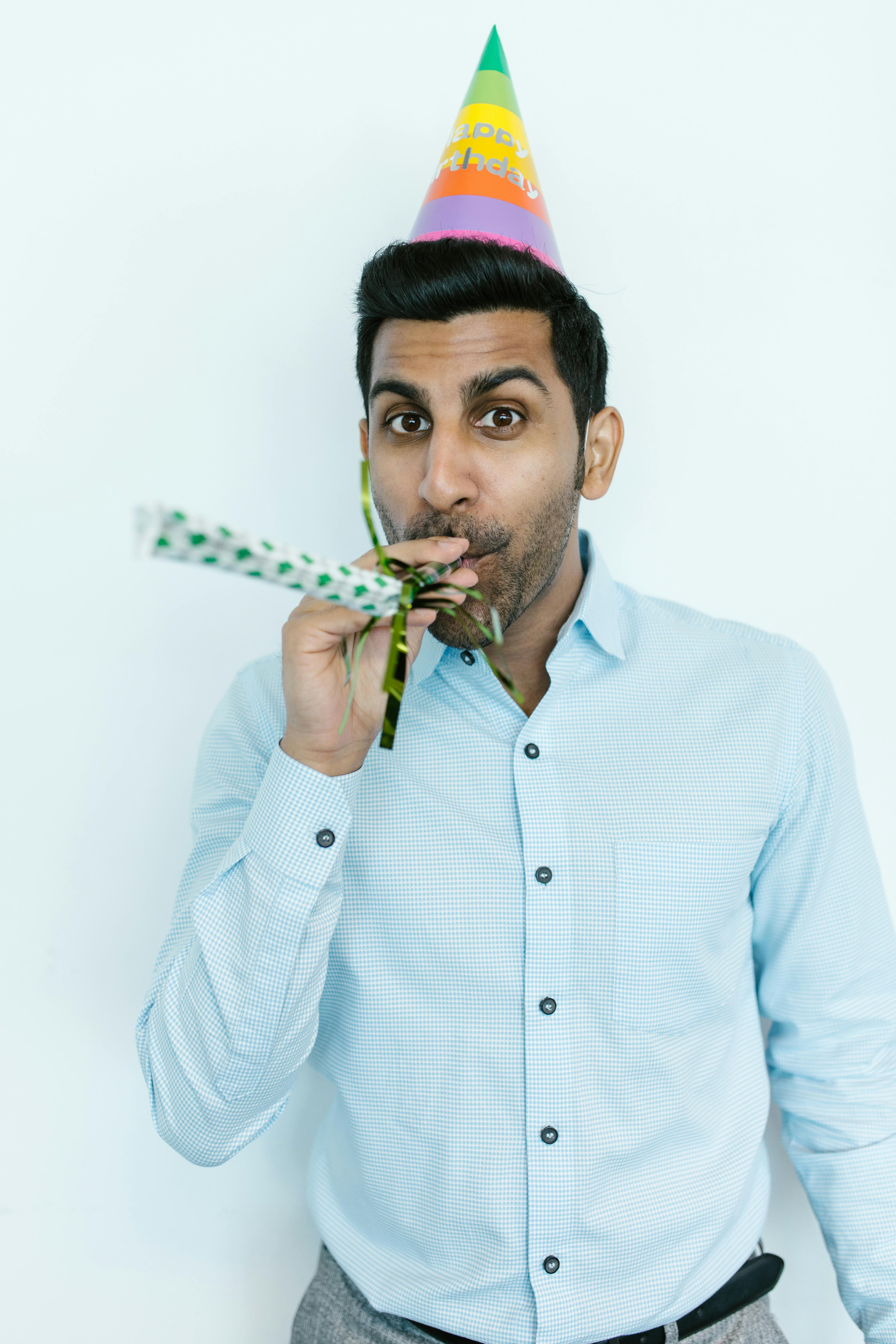 Man in White Dress Shirt Holding Green Plant