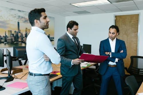 Free Men Standing in the Middle of an Office Stock Photo