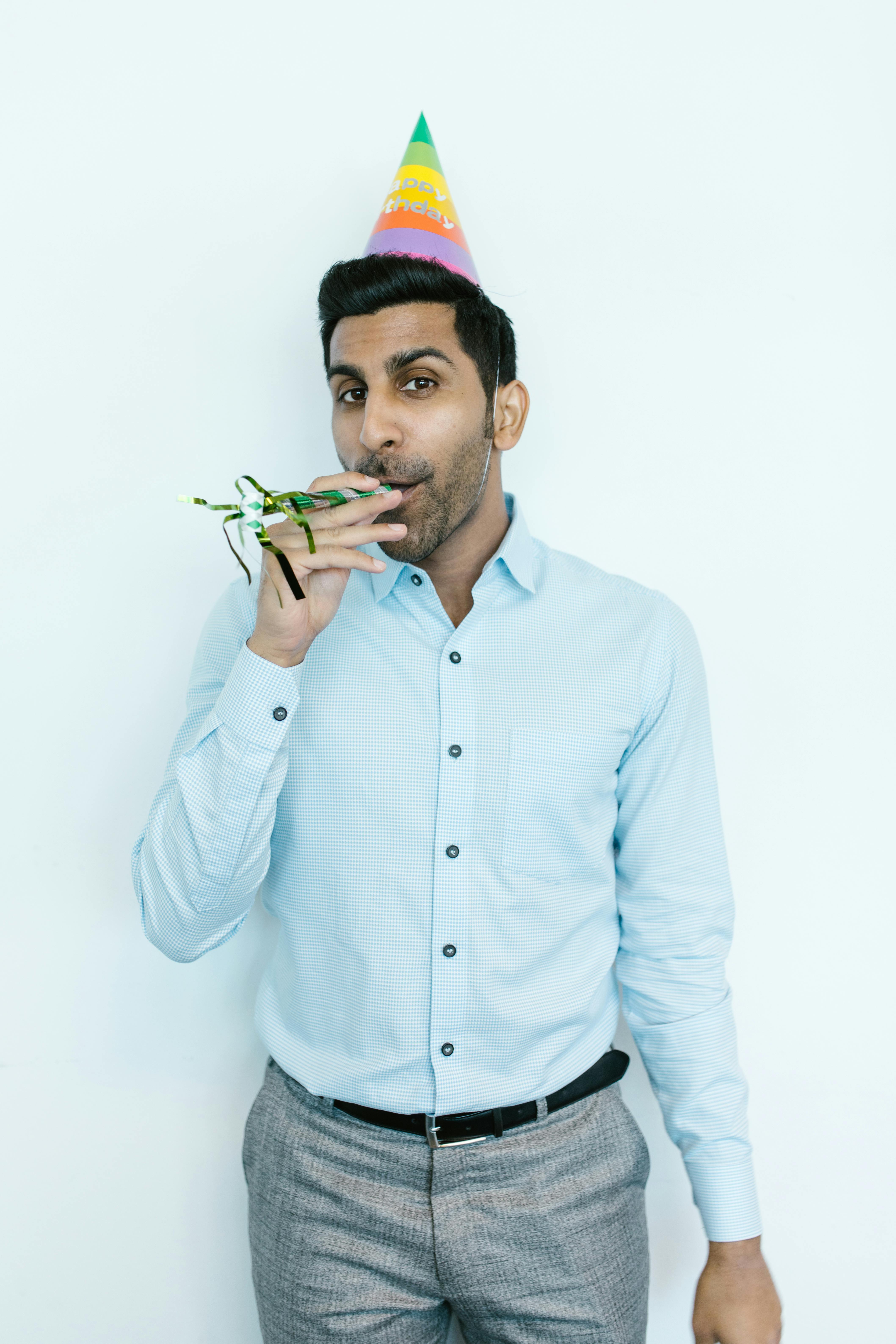 Man in White Dress Shirt Holding Green Plant