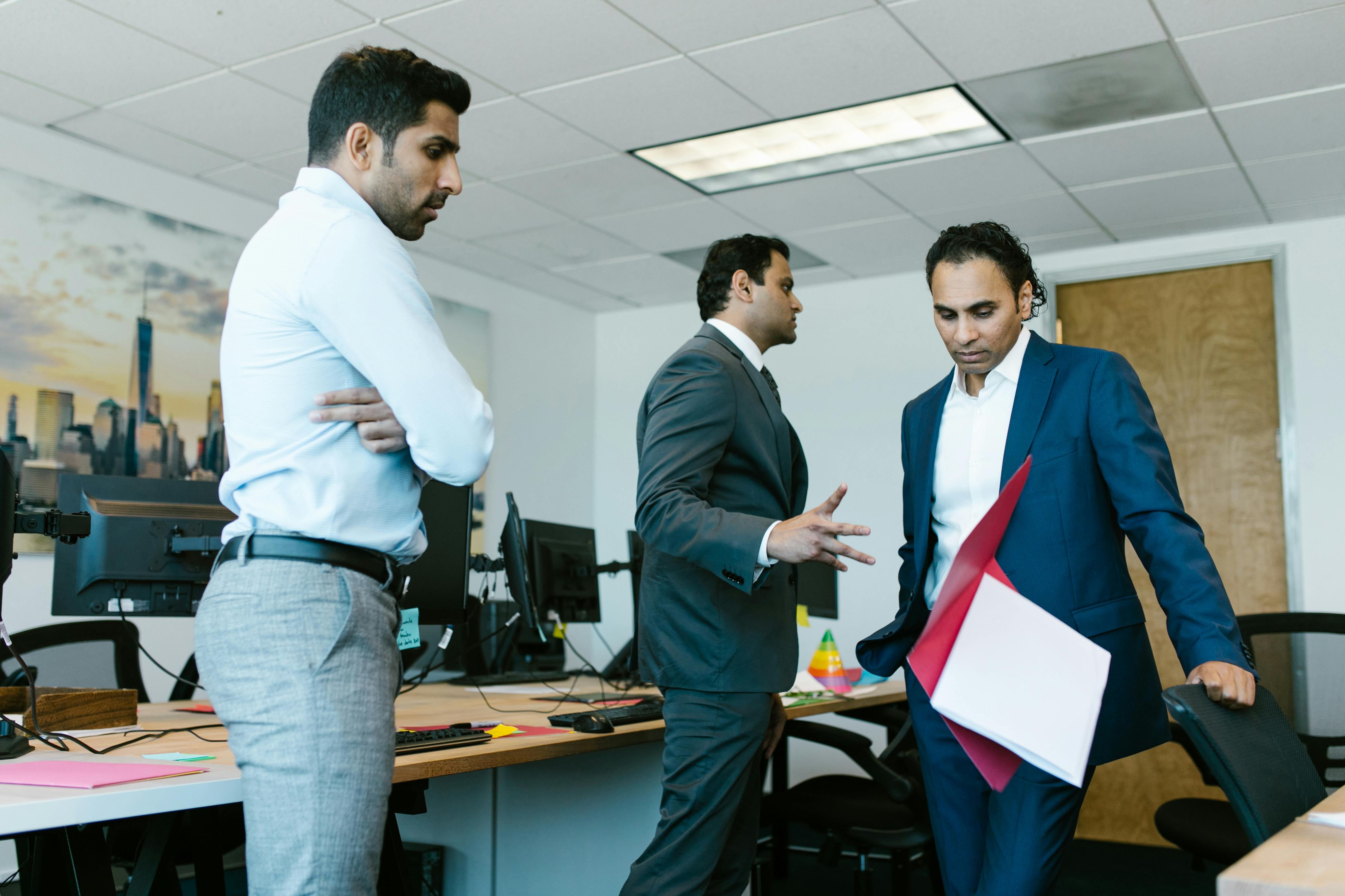 Man in Black Suit Jacket Standing Beside Man in White Dress Shirt
