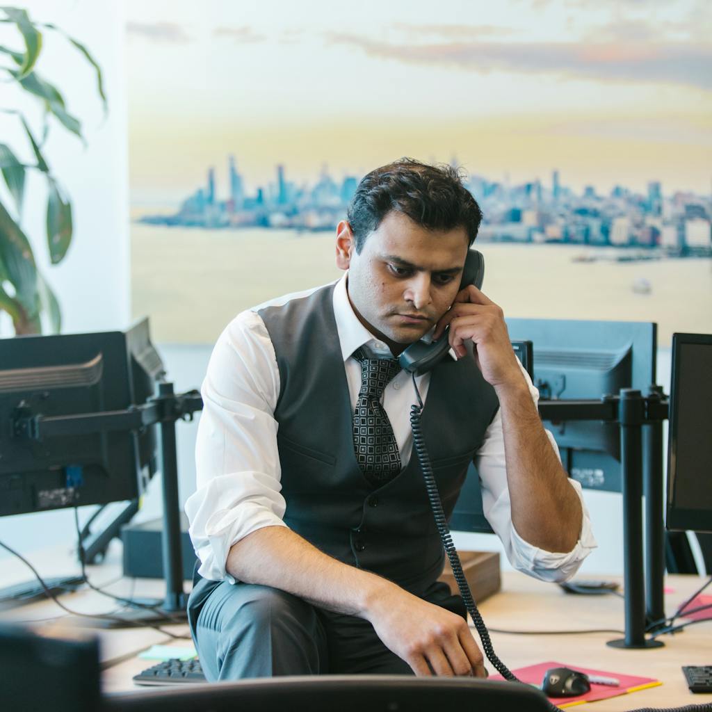 Man on the phone, possibly in an office setting; relevant to online marketing or digital marketing.