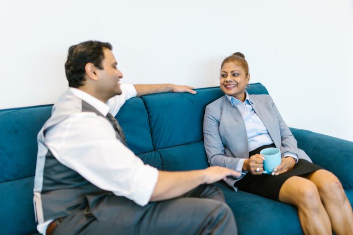 Two colleagues in conversation on a sofa, photo by RDNE Stock project on Pexels