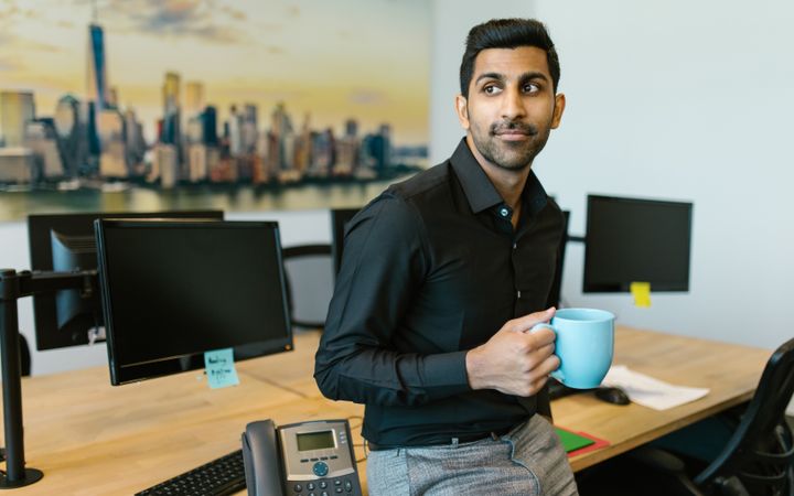 A founder at his desk with a coffee