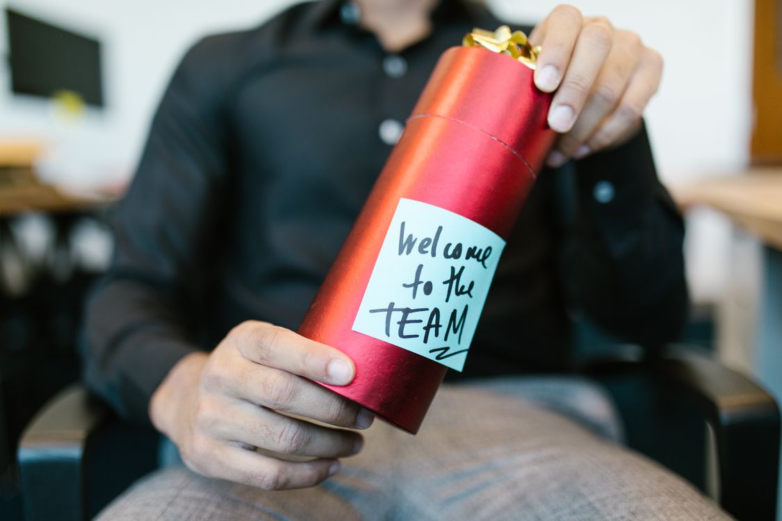 Red gift box with welcome to the team note for employee corporate gifting