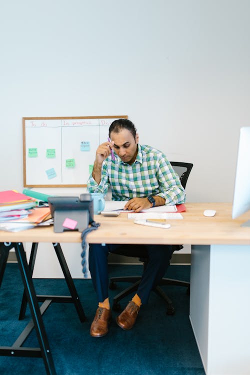 Boy in Blue and White Plaid Dress Shirt Sitting on Black Chair