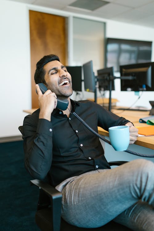 Man in Black Jacket Sitting on Chair