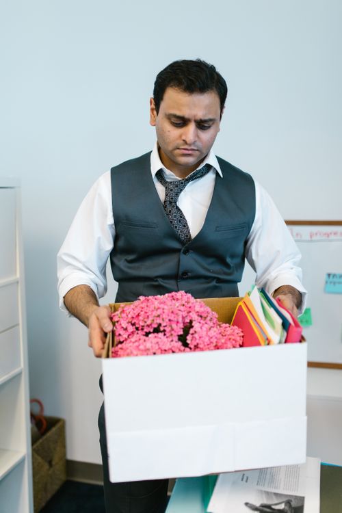 Free Businessman packing personal items in office after job termination. Stock Photo