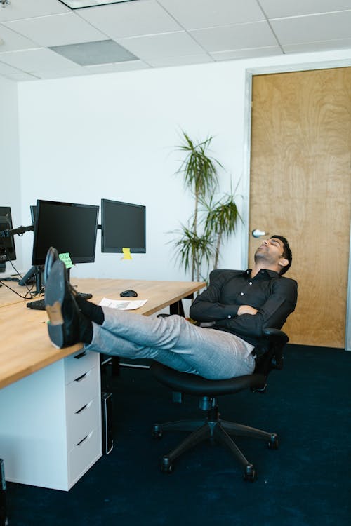 Man in Black Long Sleeve Shirt Sleeping