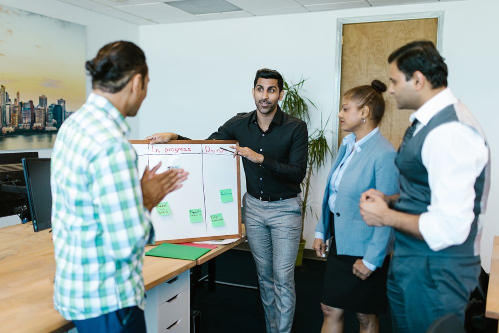 Indian team reviewing a digital strategy on a board