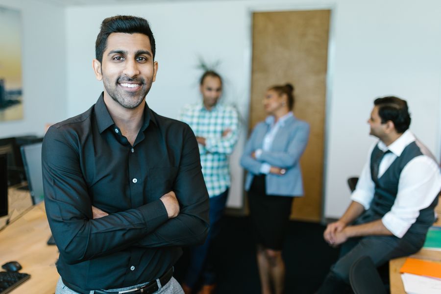 Indian marketing professional standing in a modern agency office