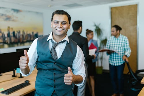 Man Wearing a Waistcoat Doing a Thumbs Up Sign