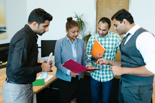 Business team engaged in discussion during a meeting in a modern office setting.
