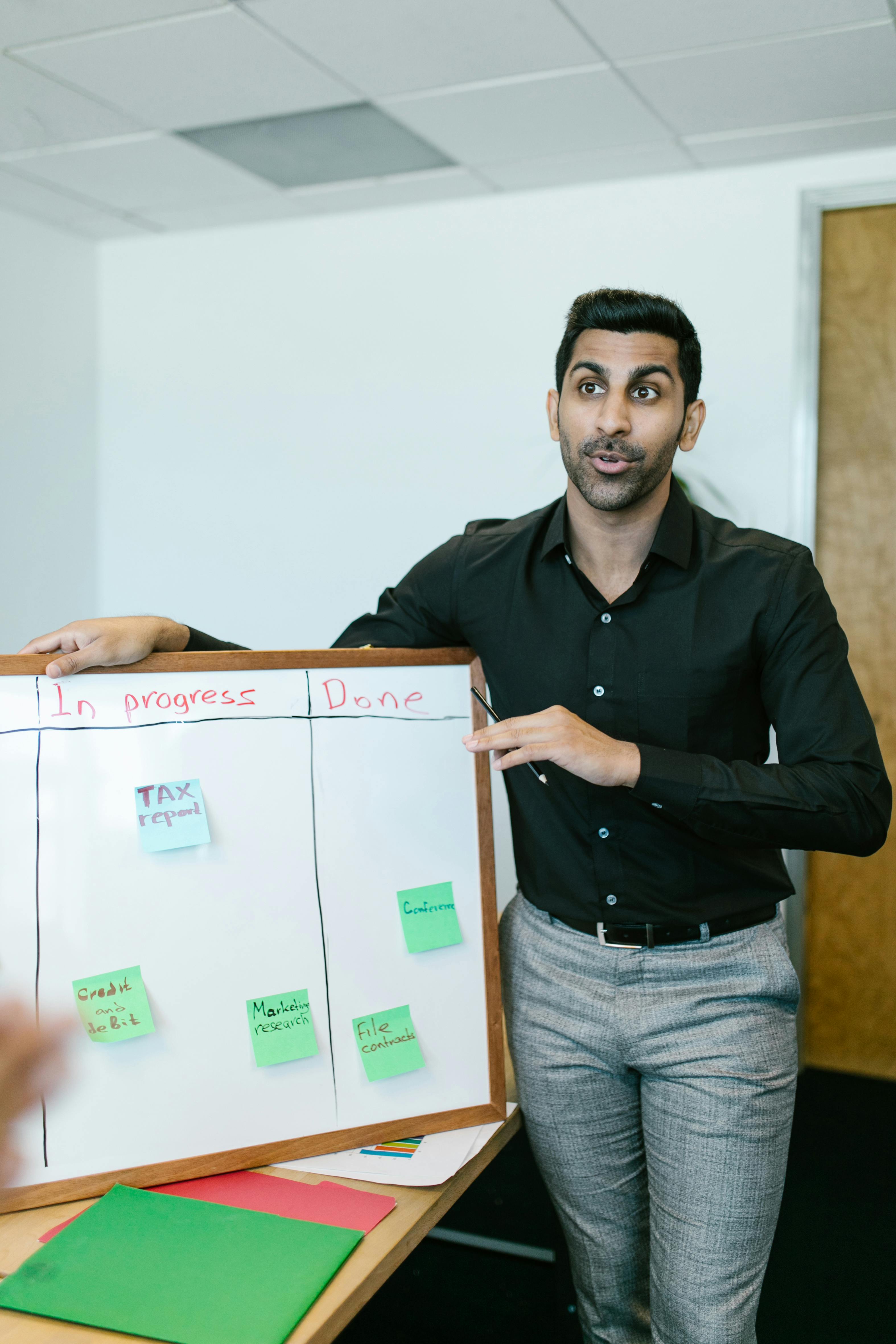 Man in Black Dress Shirt Holding White Box