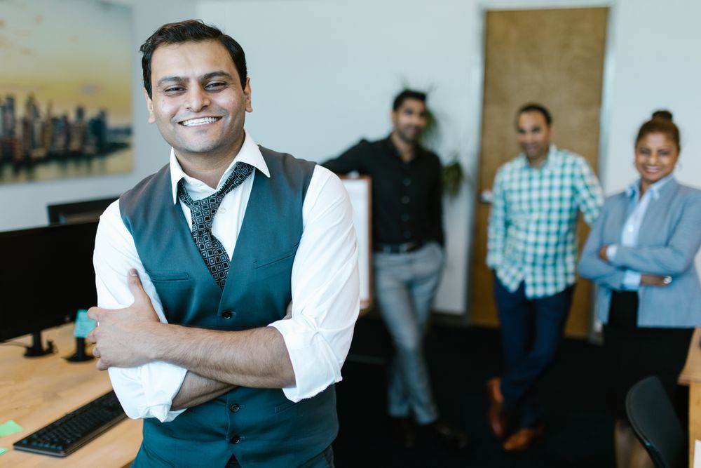 Smiling Indian business team in a modern office
