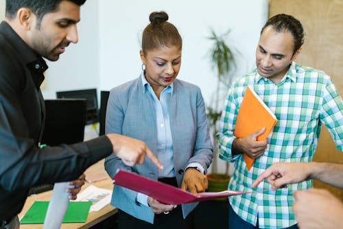 Free Woman in Gray Blazer Holding a Red Folder Stock Photo