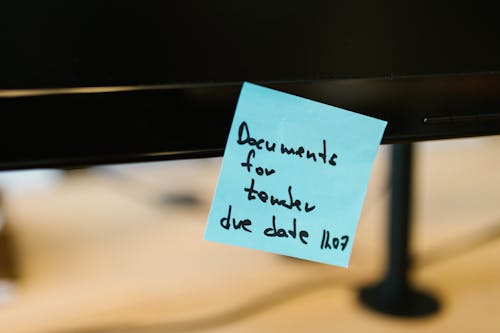 Free Reminder Written on a Sticky Note Stock Photo