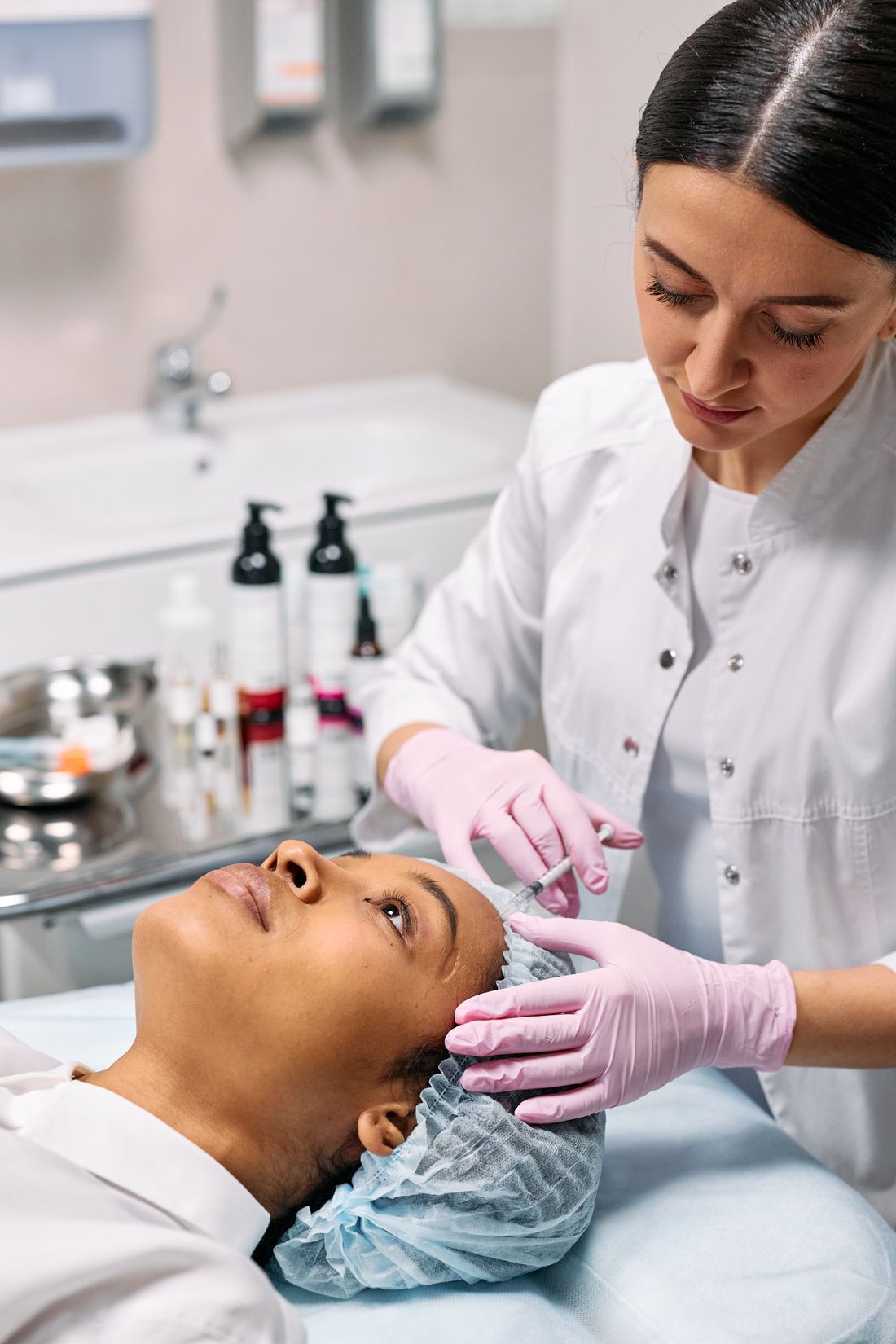 Doctor performing injectable skin booster treatment