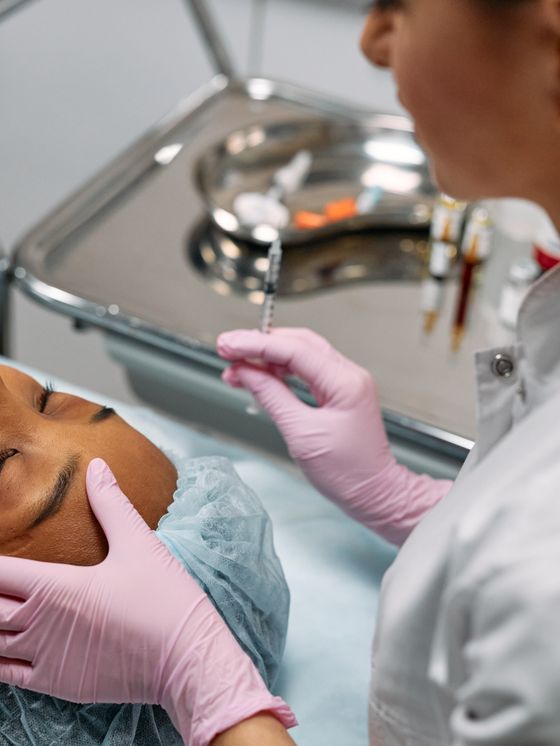 Practitioner treating a client's skin