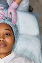 Woman Lying Down Receives Forehead Botox