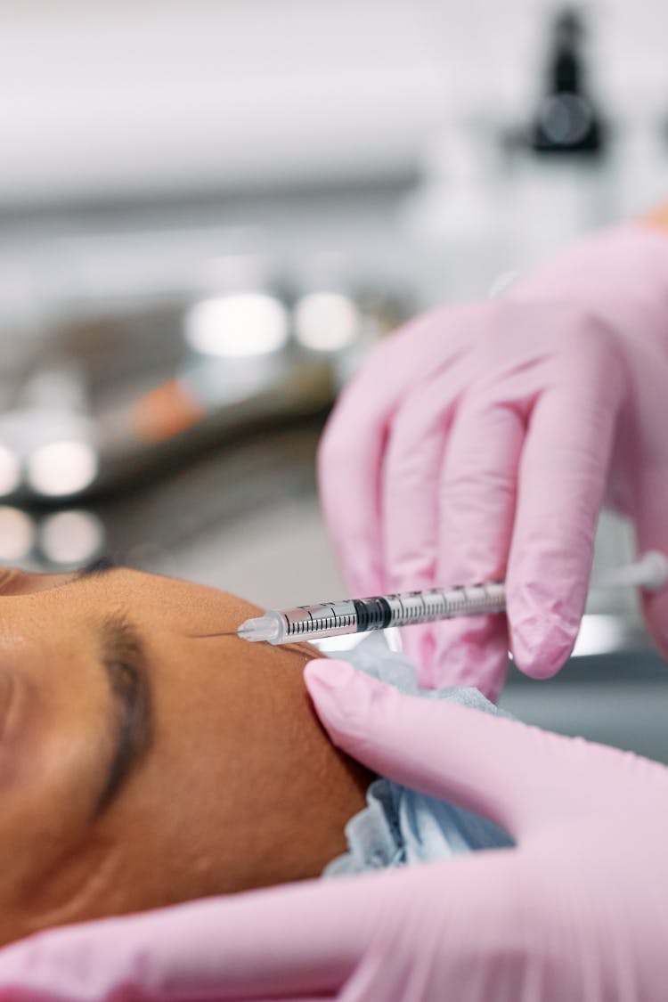 Close Up Photo Of Injecting Botox On Forehead