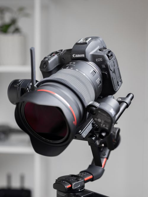 Free Close-up of a professional camera on a stabilizing gimbal indoors. Stock Photo