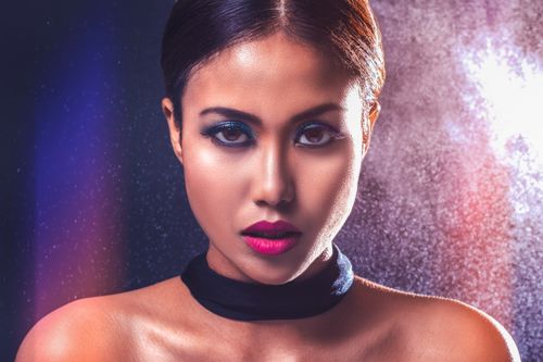 Free Captivating portrait of a woman with striking makeup and bold lighting. Stock Photo